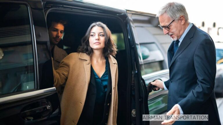 Woman exiting black car with chauffeur assistance.